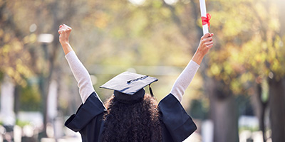 An adult graduate celebrating