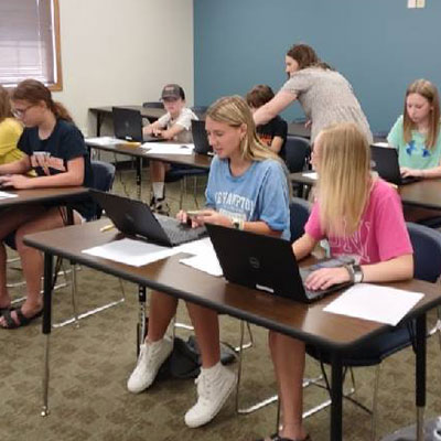 Students working on laptops in a classroom