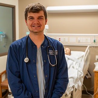 Nurse in front of lab bed