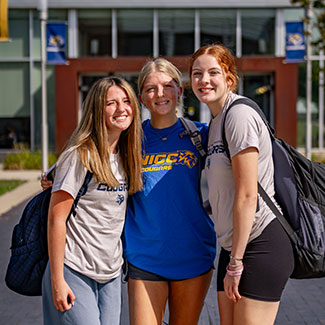 Female students posing outside on campus