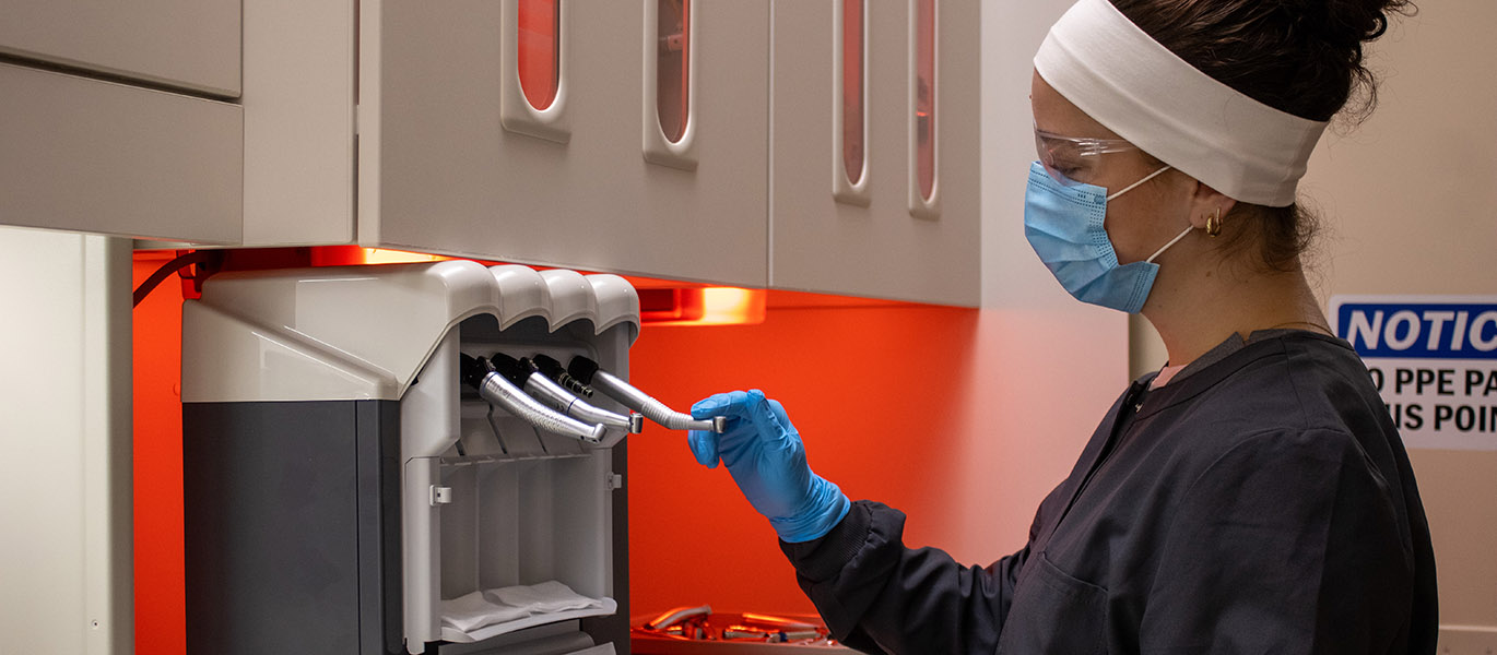 Dental Assisting student using sterilization equipment in the lab