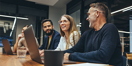 Employees work at a table.