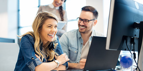 Male and Female working at a computer