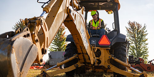 网赌网站 student use front end loaders near the Calmar campus.