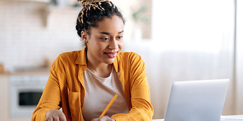 A finance officer working on a laptop