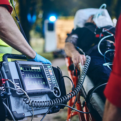 An emergency medical services worker helps a patient.