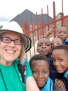 Photo of Deb Seiffert and Rwanda children.